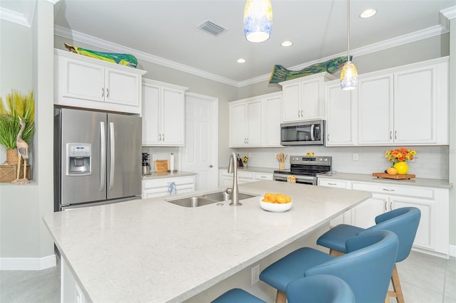 kitchen featuring stainless steel appliances, a sink, visible vents, white cabinetry, and ornamental molding