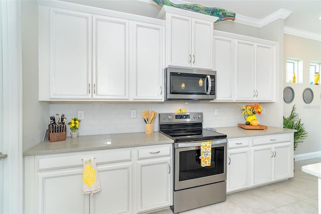 kitchen with tasteful backsplash, white cabinets, ornamental molding, stainless steel appliances, and light countertops