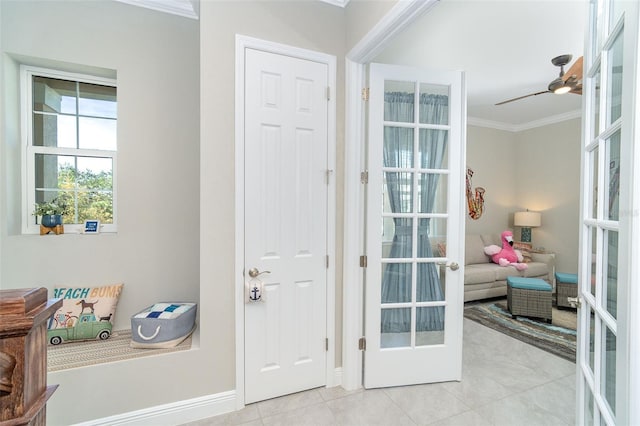 doorway with light tile patterned floors, a ceiling fan, baseboards, french doors, and crown molding