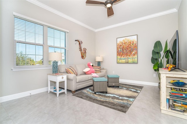 living room featuring tile patterned floors, crown molding, baseboards, and ceiling fan