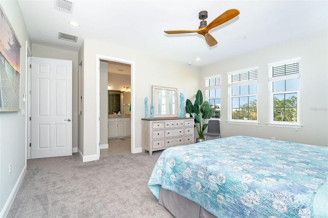 bedroom featuring connected bathroom, carpet flooring, visible vents, and baseboards