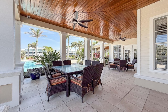 sunroom featuring ceiling fan, plenty of natural light, and wood ceiling