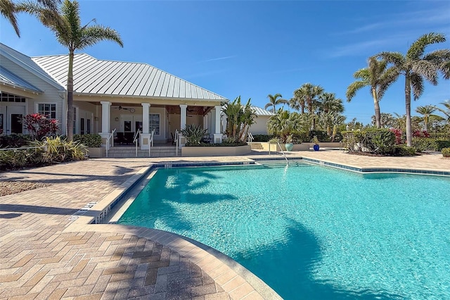 pool with a ceiling fan, french doors, and a patio