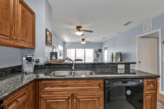 kitchen with black dishwasher, visible vents, brown cabinets, and a sink