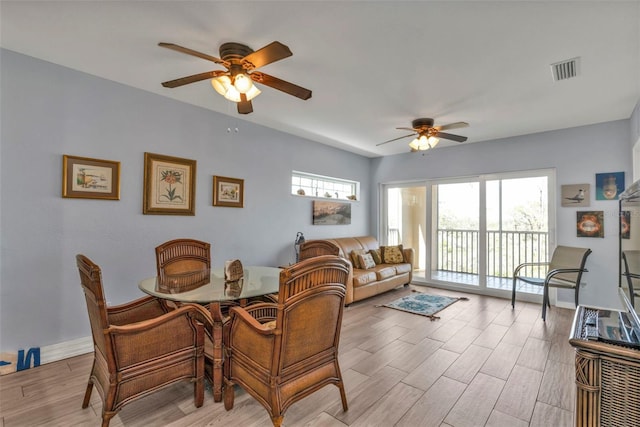 dining space featuring a wealth of natural light, light wood-style flooring, visible vents, and baseboards