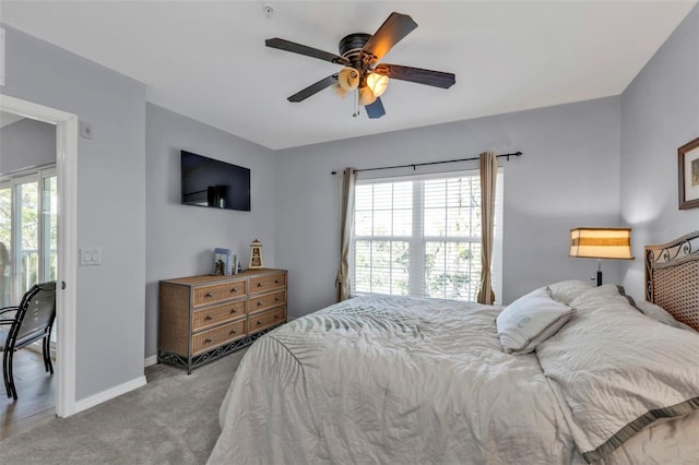 bedroom with carpet, multiple windows, baseboards, and ceiling fan