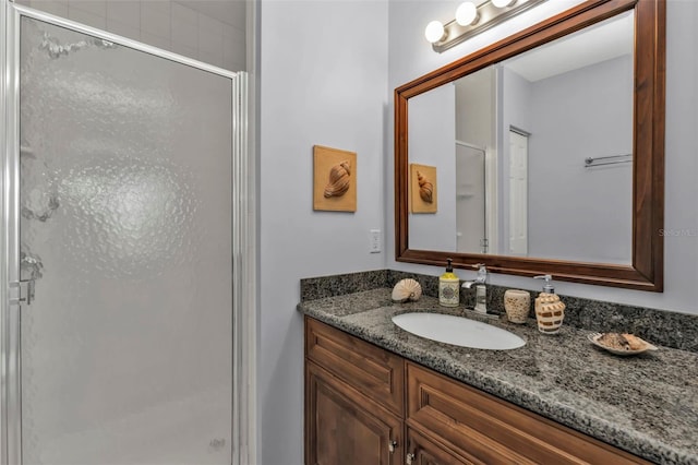 full bathroom with a stall shower and vanity