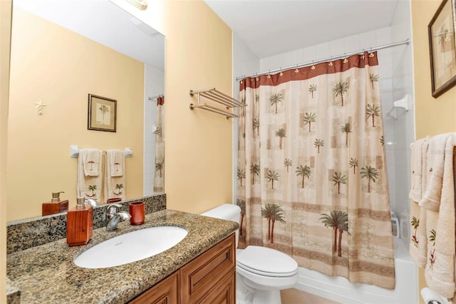 full bath featuring shower / bath combo with shower curtain, vanity, and toilet