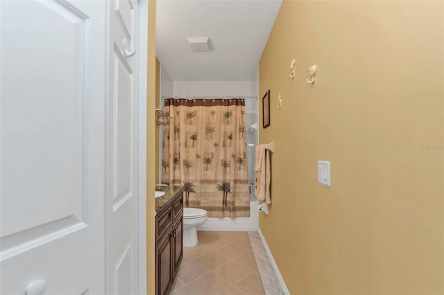 bathroom with curtained shower, toilet, vanity, tile patterned flooring, and baseboards