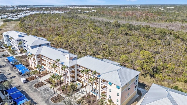 birds eye view of property with a view of trees