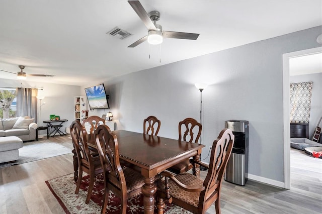 dining area featuring ceiling fan, baseboards, visible vents, and light wood-style floors