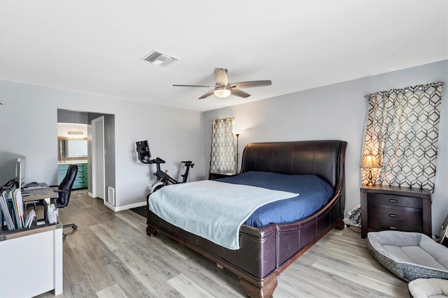 bedroom with baseboards, ceiling fan, visible vents, and wood finished floors