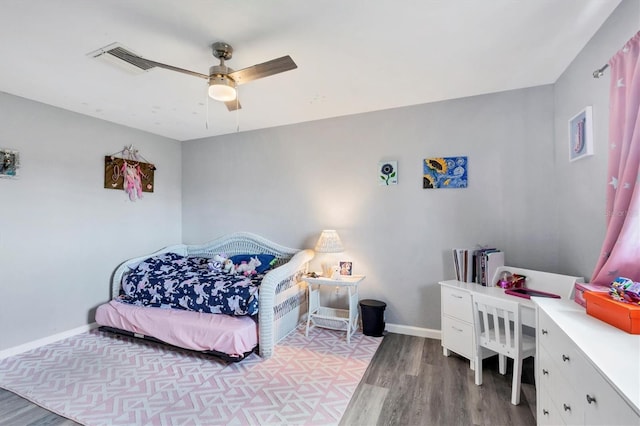 bedroom with baseboards, a ceiling fan, visible vents, and light wood-style floors