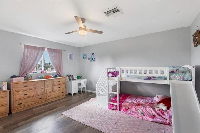 bedroom with a ceiling fan, baseboards, visible vents, and wood finished floors