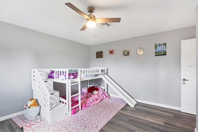 bedroom featuring a ceiling fan, baseboards, visible vents, and wood finished floors