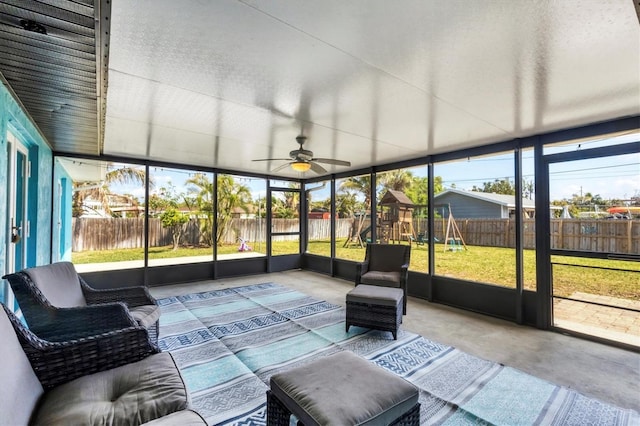 unfurnished sunroom featuring a ceiling fan and a wealth of natural light