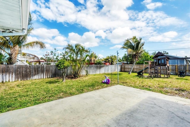 view of patio / terrace with a playground and a fenced backyard