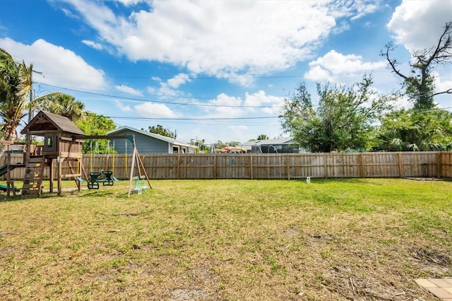 view of yard featuring a playground and fence private yard