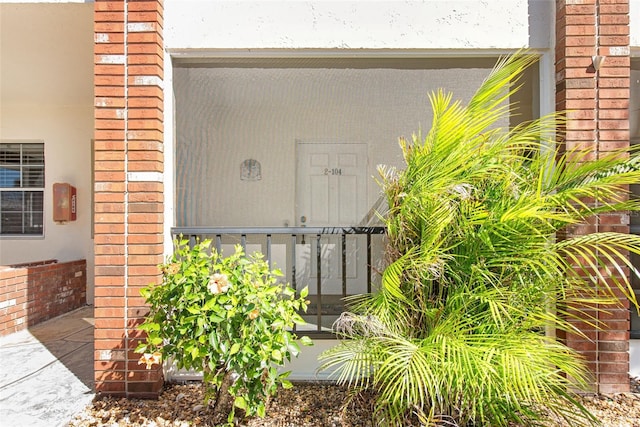 property entrance with brick siding