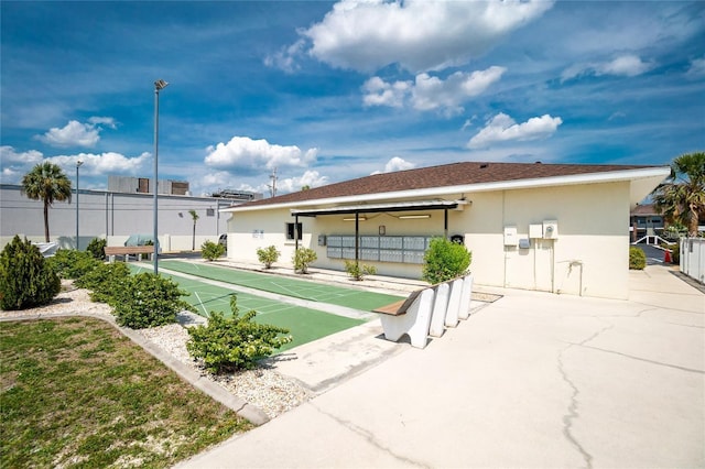 exterior space featuring fence and shuffleboard