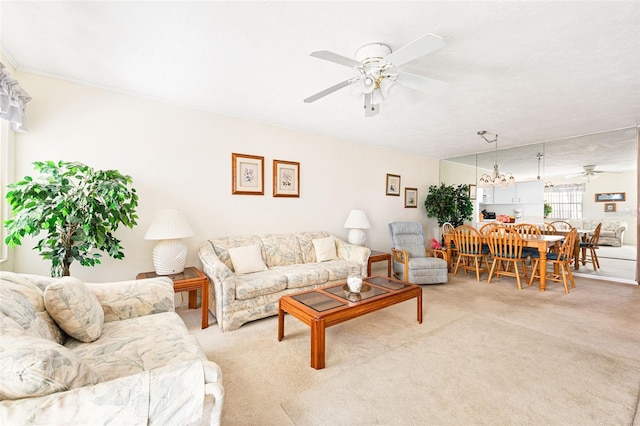 carpeted living area featuring a ceiling fan