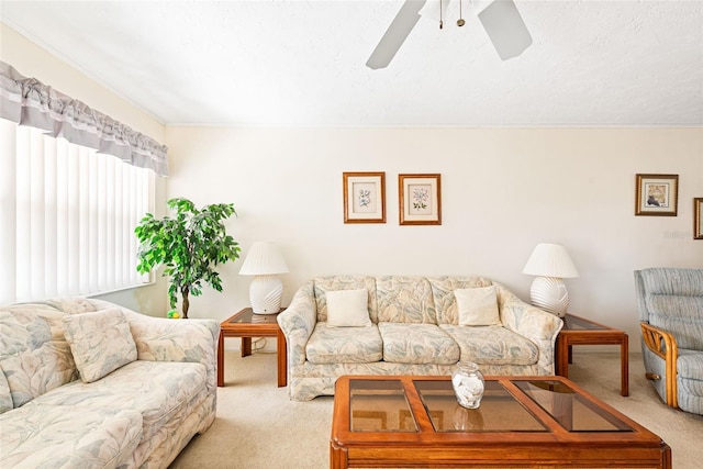 living area with ceiling fan and light colored carpet