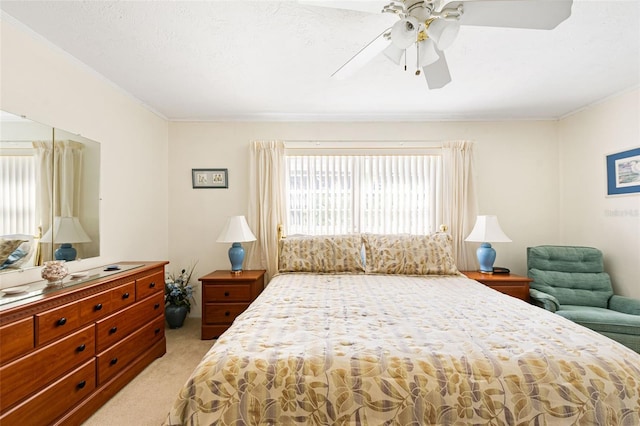 bedroom featuring ornamental molding, light carpet, and ceiling fan