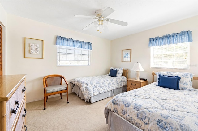 bedroom with a ceiling fan and light carpet