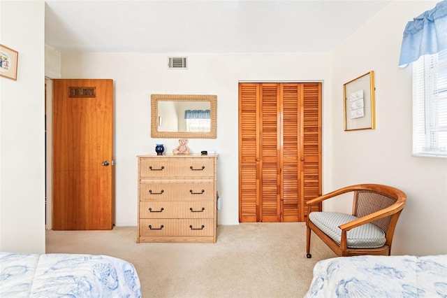 bedroom featuring carpet, visible vents, and a closet