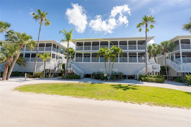 view of building exterior featuring driveway and stairs