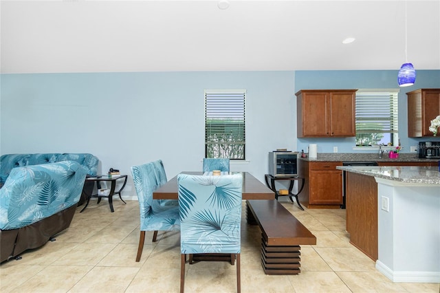 dining space featuring baseboards and light tile patterned flooring