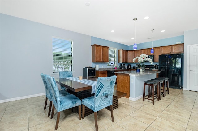 dining area featuring a healthy amount of sunlight, light tile patterned floors, baseboards, and recessed lighting