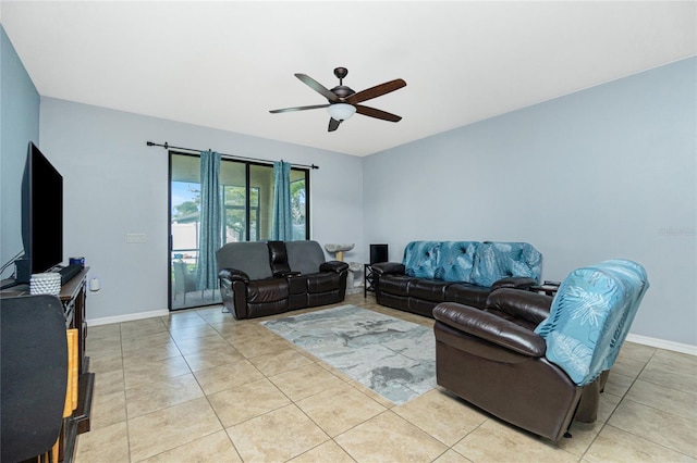 living area with a ceiling fan, light tile patterned flooring, and baseboards