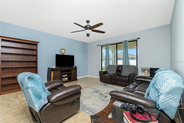 living room with a ceiling fan, tile patterned flooring, and baseboards