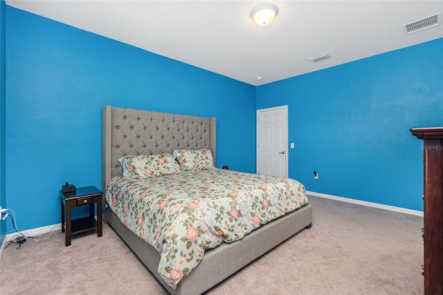 carpeted bedroom with visible vents and baseboards