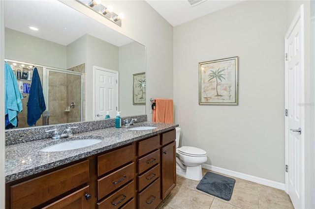 bathroom featuring double vanity, a stall shower, baseboards, and a sink