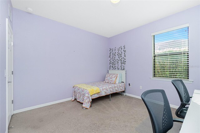 carpeted bedroom featuring baseboards