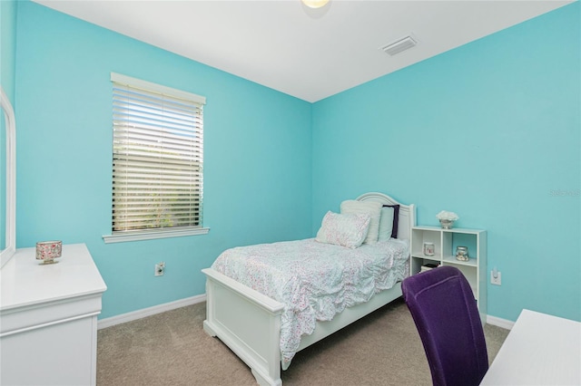 bedroom with baseboards, visible vents, and light colored carpet