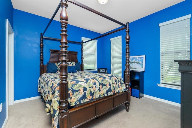 bedroom featuring carpet and baseboards