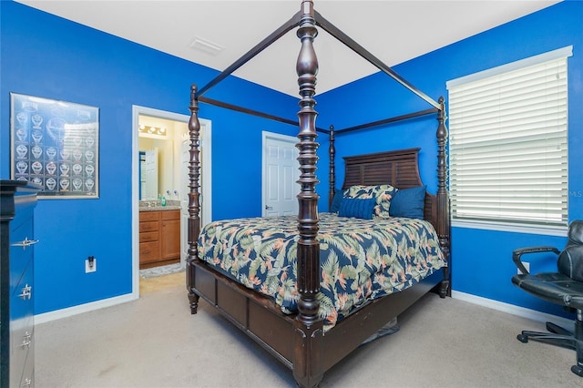 bedroom featuring ensuite bath, baseboards, visible vents, and carpet flooring