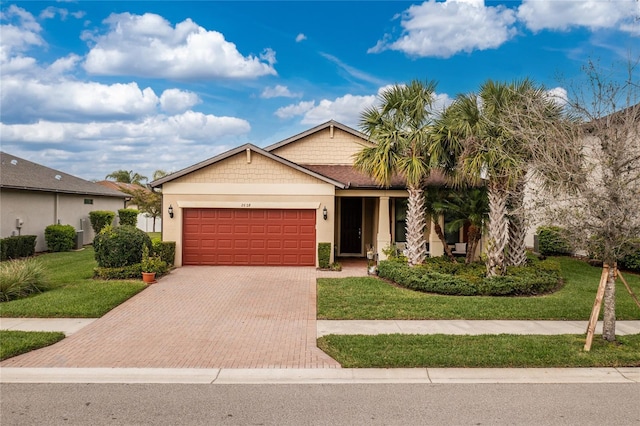 view of front facade with a garage, stucco siding, decorative driveway, and a front yard