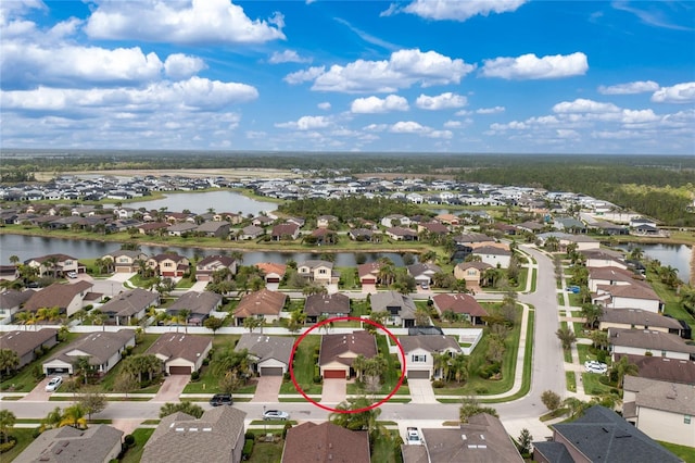 birds eye view of property with a residential view and a water view