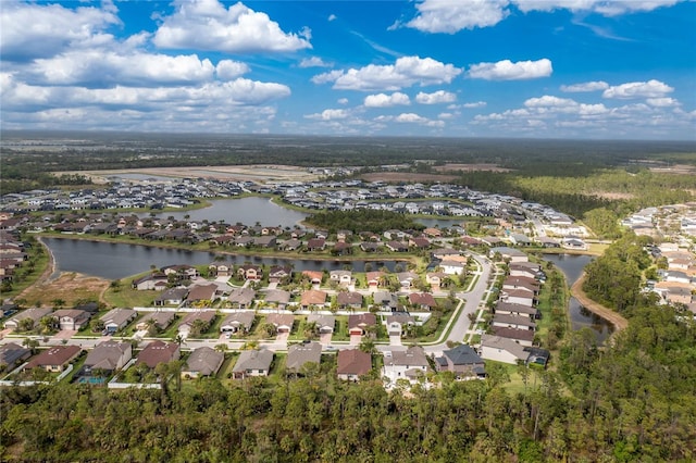 drone / aerial view featuring a water view and a residential view