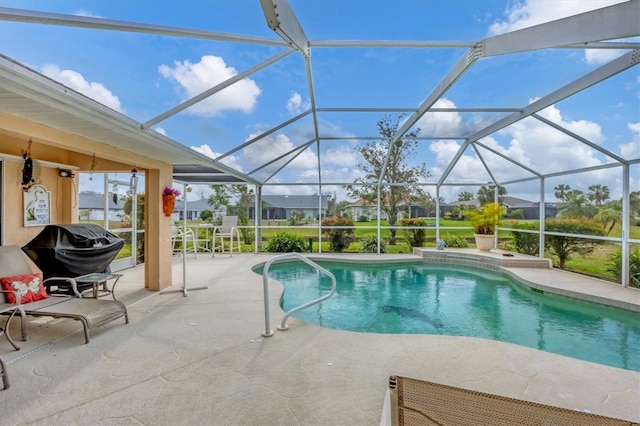 outdoor pool with glass enclosure, a patio area, and a grill