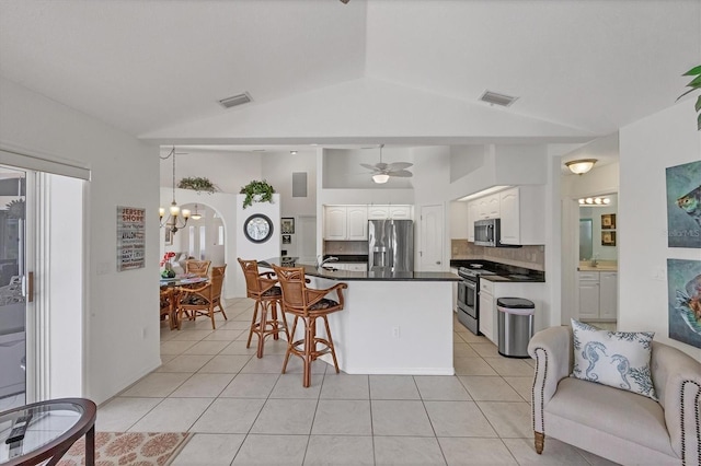 kitchen featuring stainless steel appliances, dark countertops, visible vents, white cabinets, and light tile patterned flooring