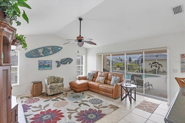 living room with vaulted ceiling, ceiling fan, light tile patterned flooring, and visible vents