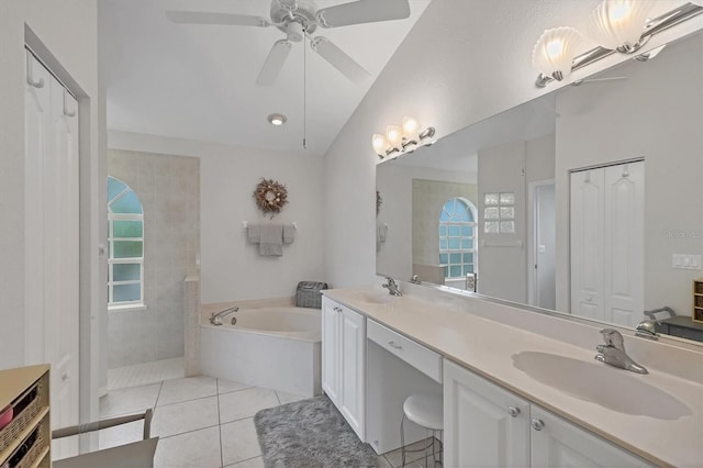 full bath featuring vaulted ceiling, a sink, a bath, and tile patterned floors