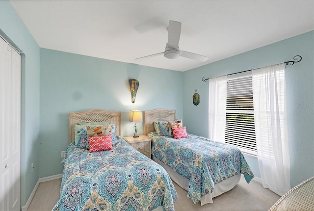 bedroom with carpet, a closet, baseboards, and a ceiling fan