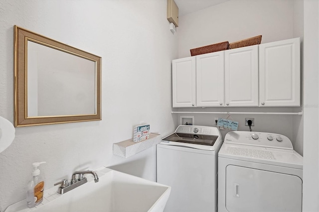 laundry room featuring cabinet space, a sink, and independent washer and dryer