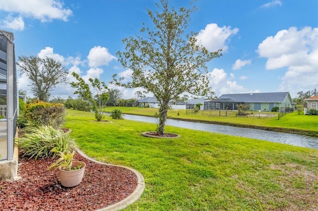 view of yard with a water view and a residential view